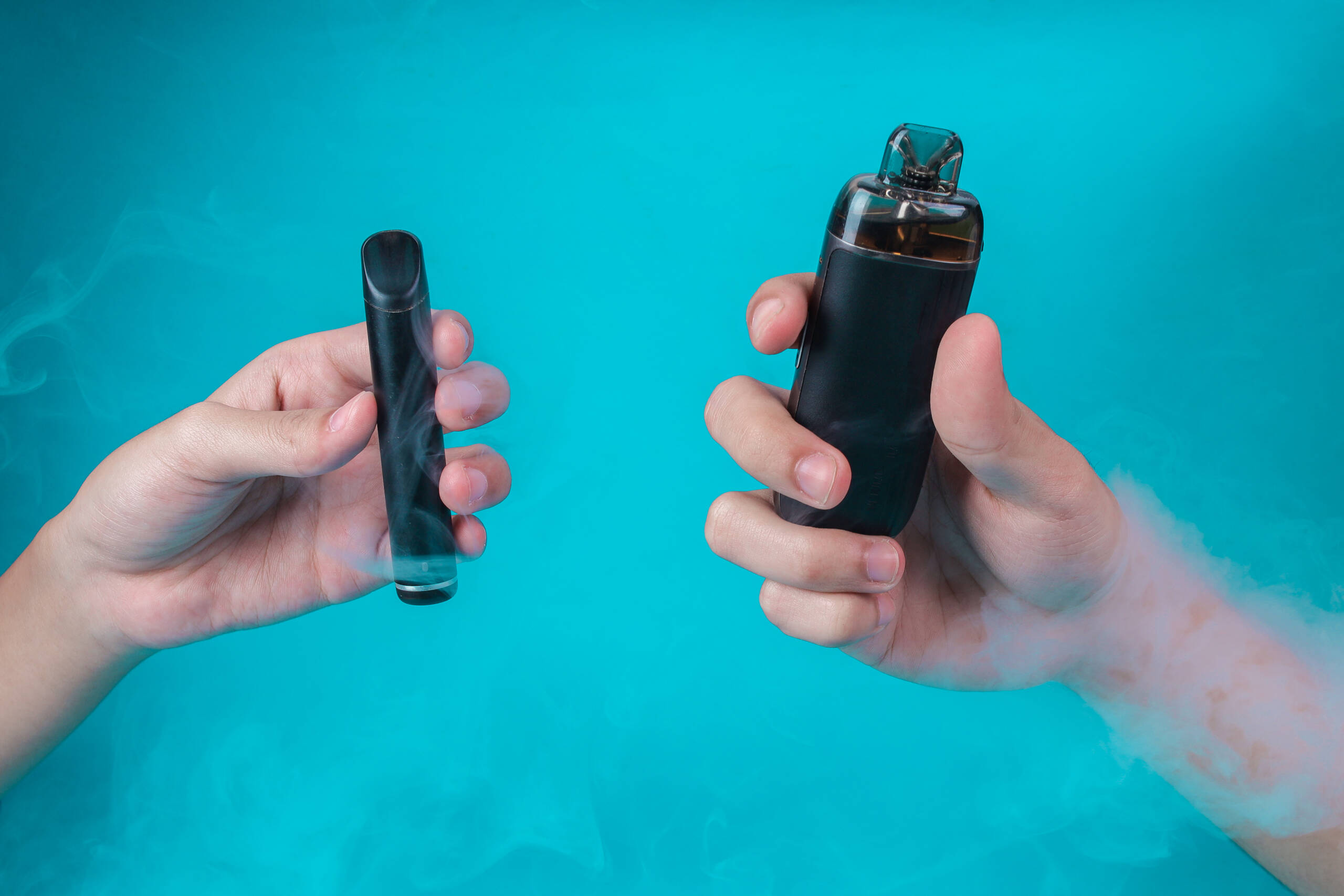 two hands holding different electronic cigarette d 2026 06 30 20 49 19 utc 1 scaled